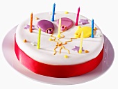 Birthday cake decorated with balloons and candles