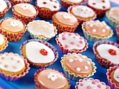 Lots of fairy cakes decorated in pink and white