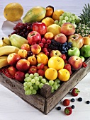 Fresh fruit and berries in a wooden crate