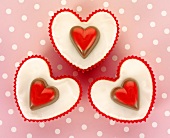Three heart-shaped cupcakes seen from above