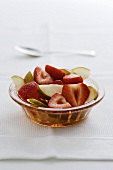 Strawberry and pear salad in a glass bowl