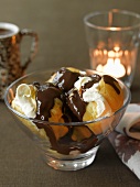 Profiteroles filled with cream and topped with chocolate sauce