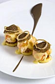 Blinis with scampi, black truffles and Parmesan sauce