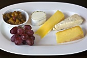 Cheese plate with grapes and pickles