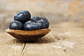 Blueberries on a wooden spoon (close-up)