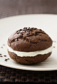 A chocolate whoopie pie filled with vanilla cream cheese
