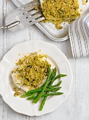 Fish fillet with an olive crust and green asparagus