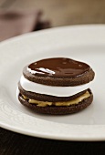 A double decker moon pie with a marshmallow filling, peanut butter and chocolate icing
