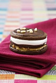 A double decker moon pie with a marshmallow filling, peanut butter and chocolate icing