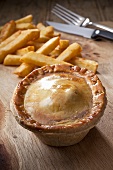 Steak and kidney pie with French fries (England)