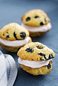 Whoopie Pies with blueberries on a blue tablecloth