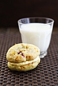 Cranberry-orange Whoopie Pies, filled with orange-vanilla cream in front of a glass of milk