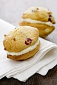 Cranberry whoopie pies, filled with white chocolate cream on a napkin
