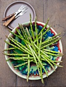 Fresh green asparagus stalks in a dish