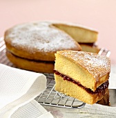 Sponge cake with jam filling on a wire rack