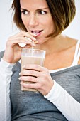 Woman drinking a milkshake through a straw