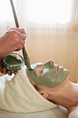 Green clay face skin theraphy massage, woman