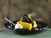 A slice of saffron cake with berries (Sweden)