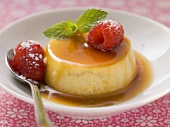 Coconut flavoured creme caramel with fresh raspberries