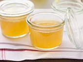 Clear goose stock in preserving glasses