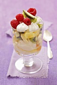 An ice cream sundae with vanilla ice cream, fresh fruit and meringue