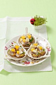 Canapes with soused herring, oranges and lemons