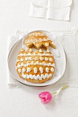An egg-shaped almond biscuit with decorated with meringue