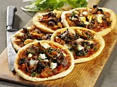 Mini pizzas with mushrooms