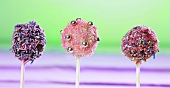Cake pops, chilled and decorated with dark and light chocolate and sugar strands