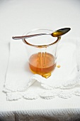 Honey in a glass and on a spoon