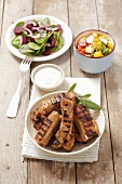 Grilled pork ribs with a horseradish dip and salad