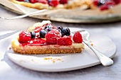 A slice of mascarpone tart with fresh berries