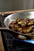 Chestnuts being roasted in a pan