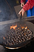 Chestnuts being roasted over an open fires (Johannserhof, South Tyrol)
