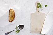 Toasted bread, a spoon and a chopping board