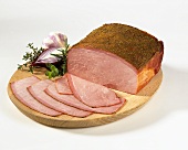 Sliced gyros ham on a wooden plate