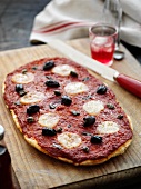 A pizza with tomato sauce, olive and bocconcino