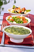 Three bowls of cooked, frozen vegetables