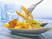 Chips on a plate and a fork