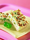 Two slices of spumoni cheesecake with nuts
