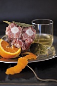 Veal tail with bay leaves, wine and orange