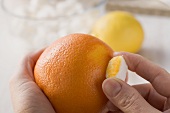 Sugar cubes being flavoured: rubbing onto an orange