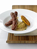 Duck sausage with Champagne Kraut and potato pancakes