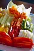Raw vegetable platter with vegetable flowers and lemons
