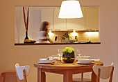 A dining area with a serving hatch into the kitchen