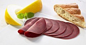 Sliced cured beef, pita bread and honey melon