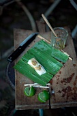 Grilling marinated halibut wrapped in banana leaves