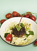 A meatball with capers, tomatoes and Farfalle