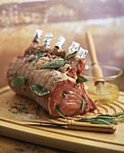 Raw pork loin with sage and other ingredients
