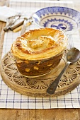 A beef and kidney bean pie in a pie dish